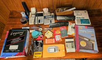 A Large Assortment Of Office Supplies Incl. Hanging File Folders, Calculators, Hole Puncher, Pencil Sharpener