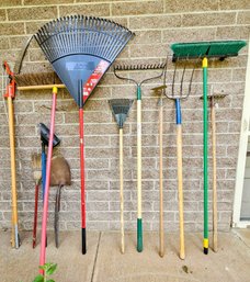 An Assortment Of Yard Tools Incl. Rakes, Pitch Forks, Broom And More