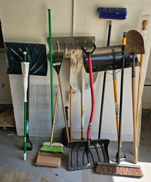 An Assortment Of Garden Tools  With Shovels, Brooms And More