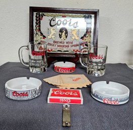 A Collection Of Vintage Coors Bar Essentials Incl. Bar Mirror, Ashtrays, Mugs, Cards,  Coasters And More