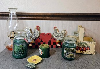 An Assortment Of Country Decor Incl. Unused Candles, Hurricane Lamp, Chicken Wooden Hat Holder And More