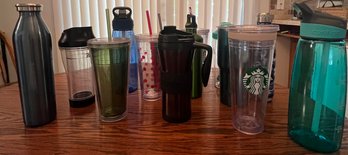 Over A Dozen Plastic And Metal Drink Containers Of Various Sizes