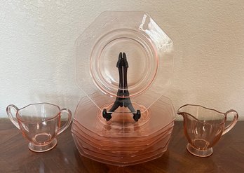 A Collection Of Vintage Pink Depression Glass With 8 Saucers And Cream And Sugar