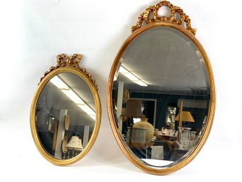 Two Modern Oval Mirrors With Ribbon Tops