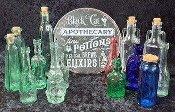 Collection Of Glass Bottles And Metal Apothecary Sign