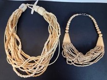 SIMILAR BUT VERY DIFFERENT NECKLACES--ONE MADE OF BONE AND ONE MADE OF RESIN