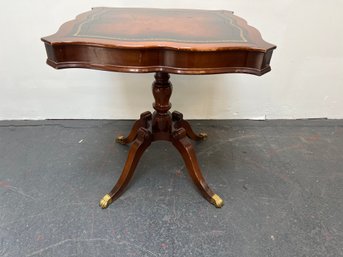 Mahogany Accent Table With A Tooled Leather Top And Brass Claw Feet