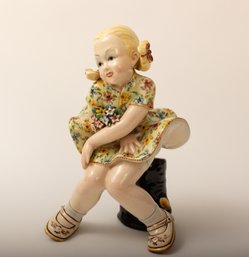 Porcelain Girl Sitting On Tree Trunk