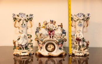 Three Piece German Porcelain Clock With Vases