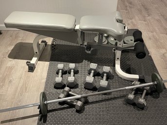 Weight Bench By Tuff Stuff With Barbell And Assorted Dumbells