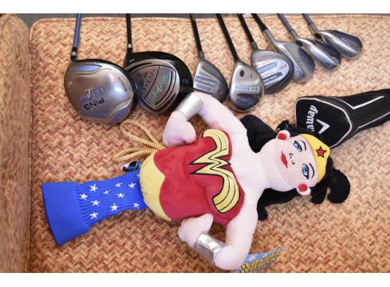Collection Of Golf Clubs And Covers