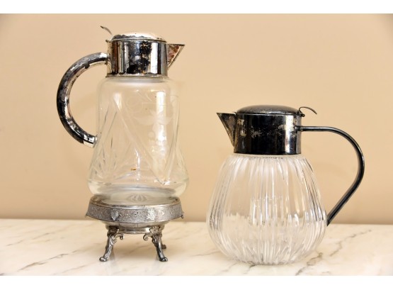 Pair Of Silver Plate Handled Glass Pitchers