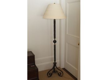 A Wrought Iron Floor Lamp With Custom Shade