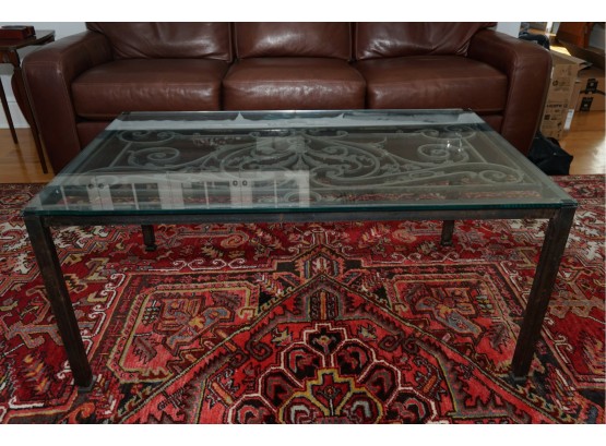 A Wrought Iron Coffee Table With Glass Top (view Description)