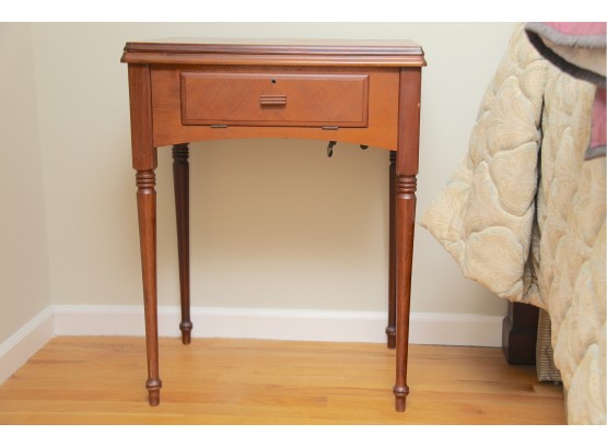 A Vintage Sewing Machine Table Used As A Side Table
