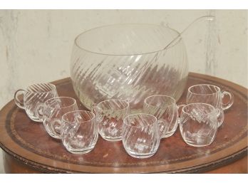 A Glass Punch Bowl With Cups And Glass Ladle