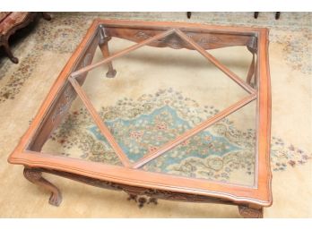 A Carved Wood Claw & Ball Foot Glass Top Coffee Table