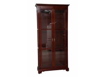 A Two Door Mahogany Lighted Glass Curio Cabinet