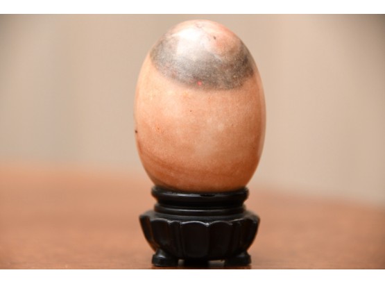A Polished Marble Egg On A Stand