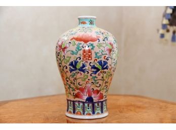 An Asian Flower Vase Decorated In Pinks And Blues