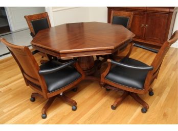 An Octagonal Mahogany Gaming Table With Four Nailhead Trim Chairs On Wheels