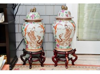 A Pair Of Foo Dog Covered Urns With Stands