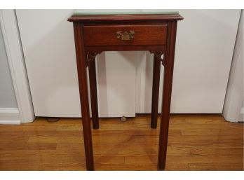 A Wooden Side Table With Glass Top
