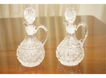 A Pair Of Lidded Crystal Pitchers