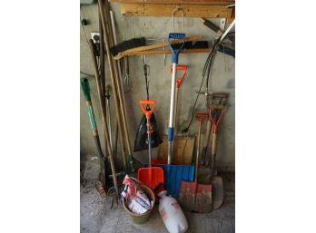 Group Of Garden Tools Including Shovels And Rakes