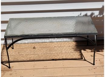 A Wrought Iron Glass Topped Outdoor Coffee Table