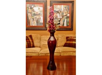 A Red Glass Lined Vase Vase With Faux Flowers