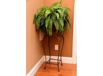 A Clay And Moss Pot With Faux Ferns And Painted Metal Plant Stand