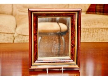 An Antique Wooden Framed Mirror