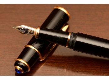 A Black And Gold Cartier Fountain Pen With 18k Gold Knib READ