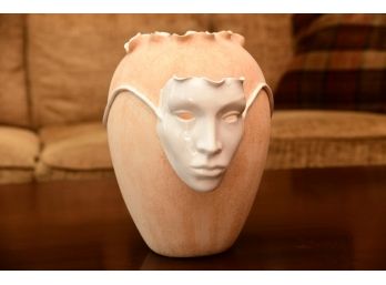 A Free Form Tan Porous Vase With Porcelain Theater Mask