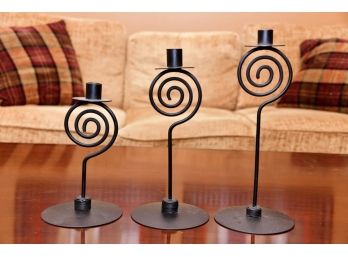 A Trio Of Black Metal Spiral Candle Holders