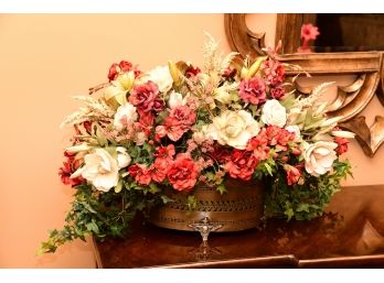 A Clawfoot Metal Center Piece With Faux Flowers