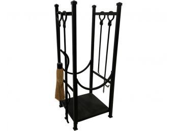 A Black Painted Metal Fireplace Log Holder With Tools