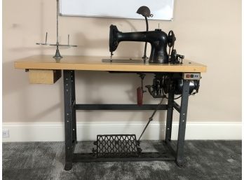 An Antique Singer Sewing Machine Table With Foot Pedal