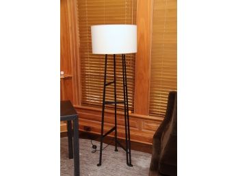 A Modern Hammered Black Metal Floor Lamp With White Shade