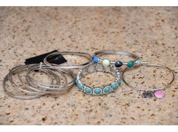 Group Of Silver Colored Bracelets Including Rhinestone Accent And Teal Center Stones