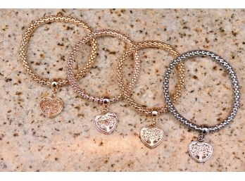 Group Of Gold And Silver Colored Bracelets With Heart Motif