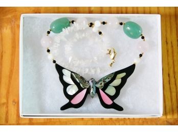 A Butterfly Pendant With Pink And Green Stone Necklace Strand