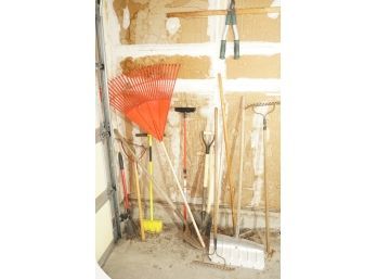 Group Of Garden Tools Including Shovels, Rakes, And Trimmers