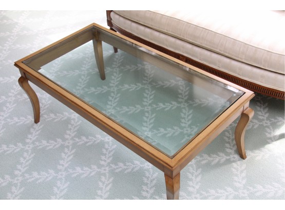 A Maple Coffee Table With Beveled Edge Glass