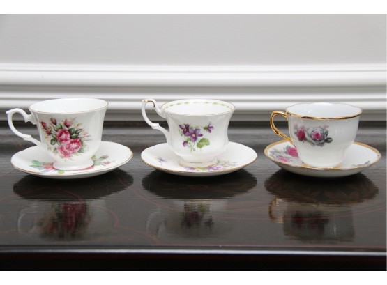 A Collection Of  Three Tea Cups And Saucers