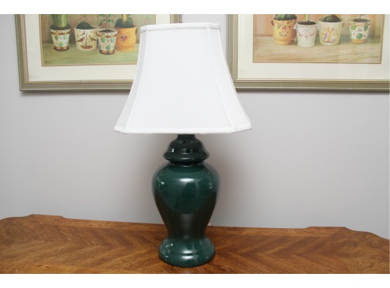A Green Table Lamp With White Shade