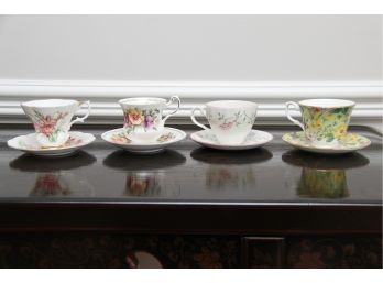 A Collection Of Four Tea Cups And Saucers