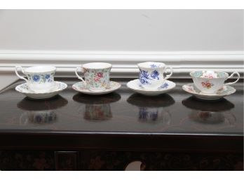 A Collection Of Four Tea Cups And Saucers