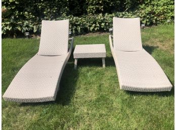 A Pair Of All Weather Outdoor Weaved Lounge Chairs With Side Table